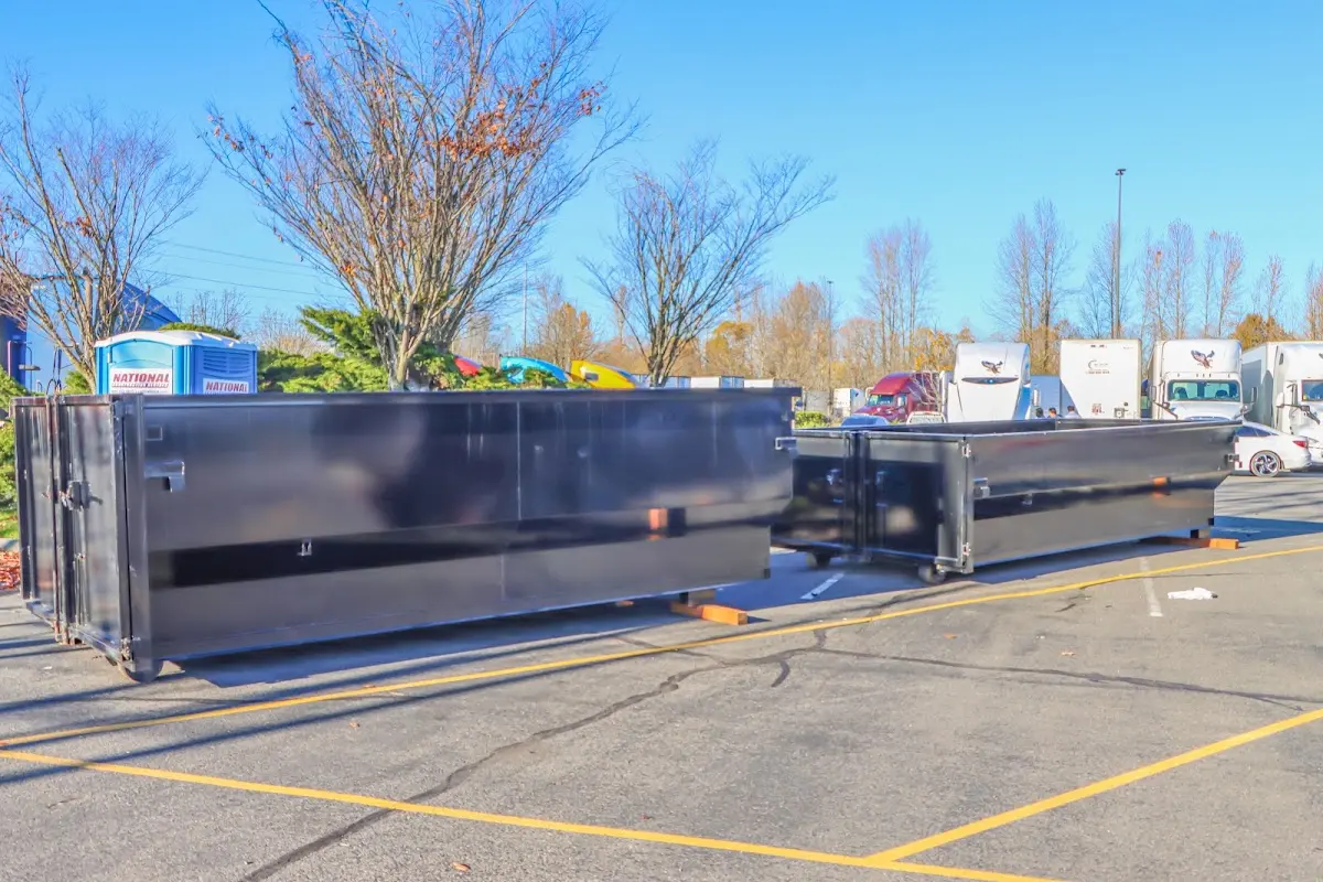 Professional dumpster rental service with roll-off container on residential driveway in Hanover